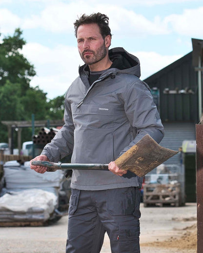 Grey Coloured TuffStuff Sutherland Waterproof Windbreaker Smock On A Factory Background 