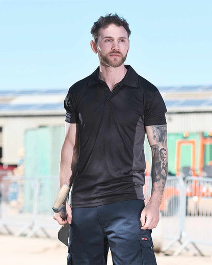 Black Coloured TuffStuff Elite Polo Shirt On A Warehouse Background 