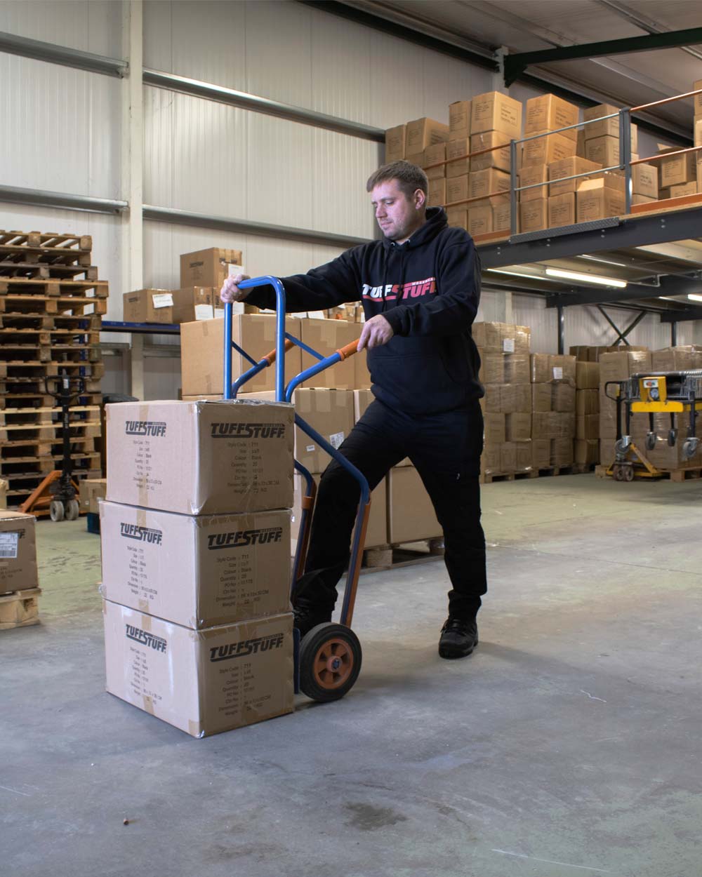 Black coloured TuffStuff Logo Hoodie on Warehouse background 